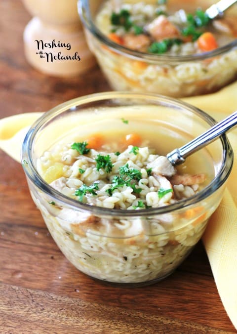 Alphabet Soup in a small clear glass bowl with a spoon