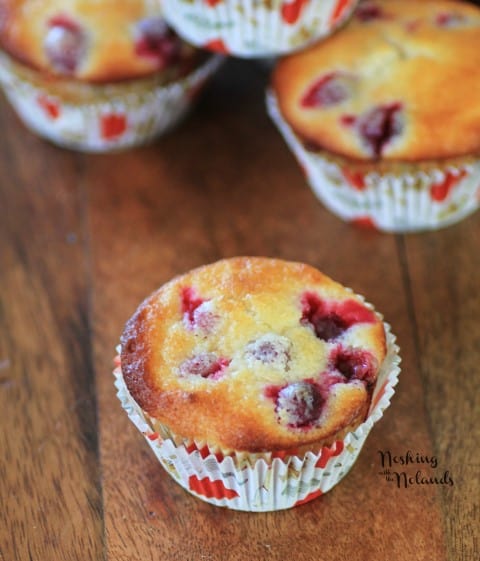 Cranberry Lemon Almond Muffins on a wooden cutting board