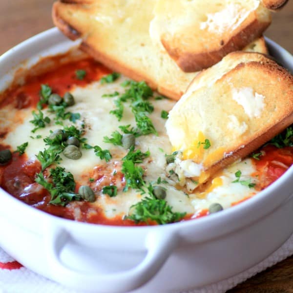 Eggs in Purgatory with a slice of toast dipped into the egg yolk