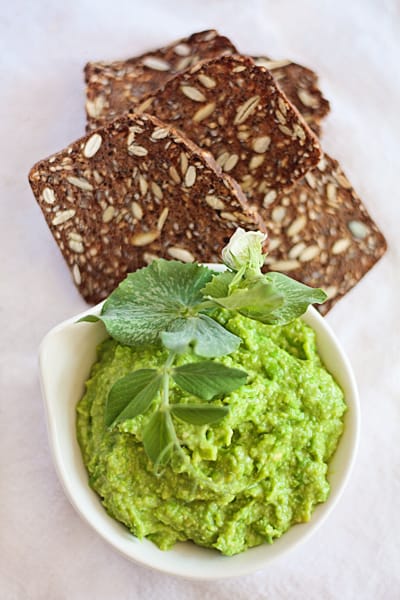 Lesley Stowe_Pea-and-Avocado-dip in a white bowl with whole grain crackers