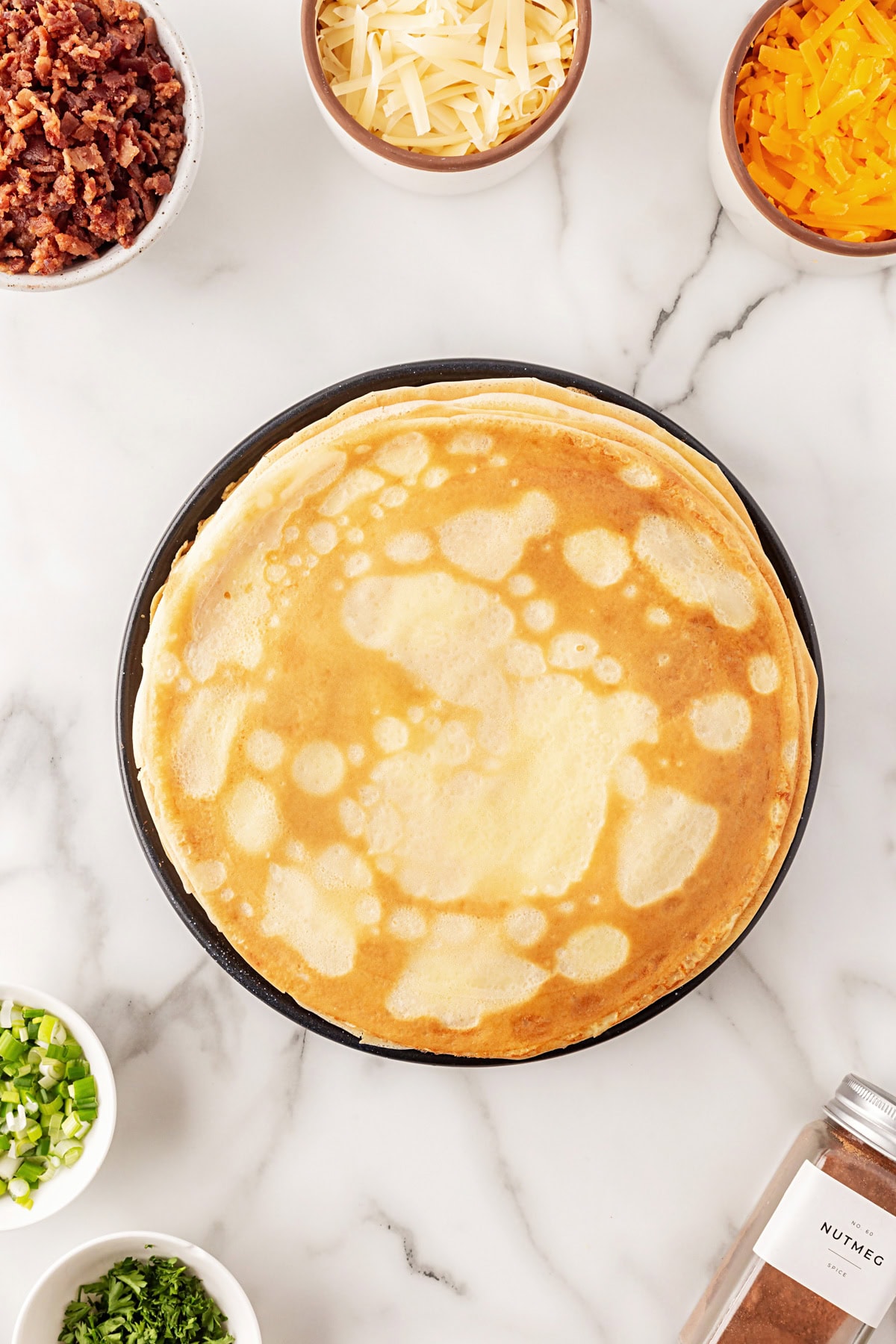This recipe for Crepes Lorraine is a time-honored treasure that I have been making for over 40 years. Friends and family love this recipe, and I am thrilled to offer it to you also. Cooked crepes.