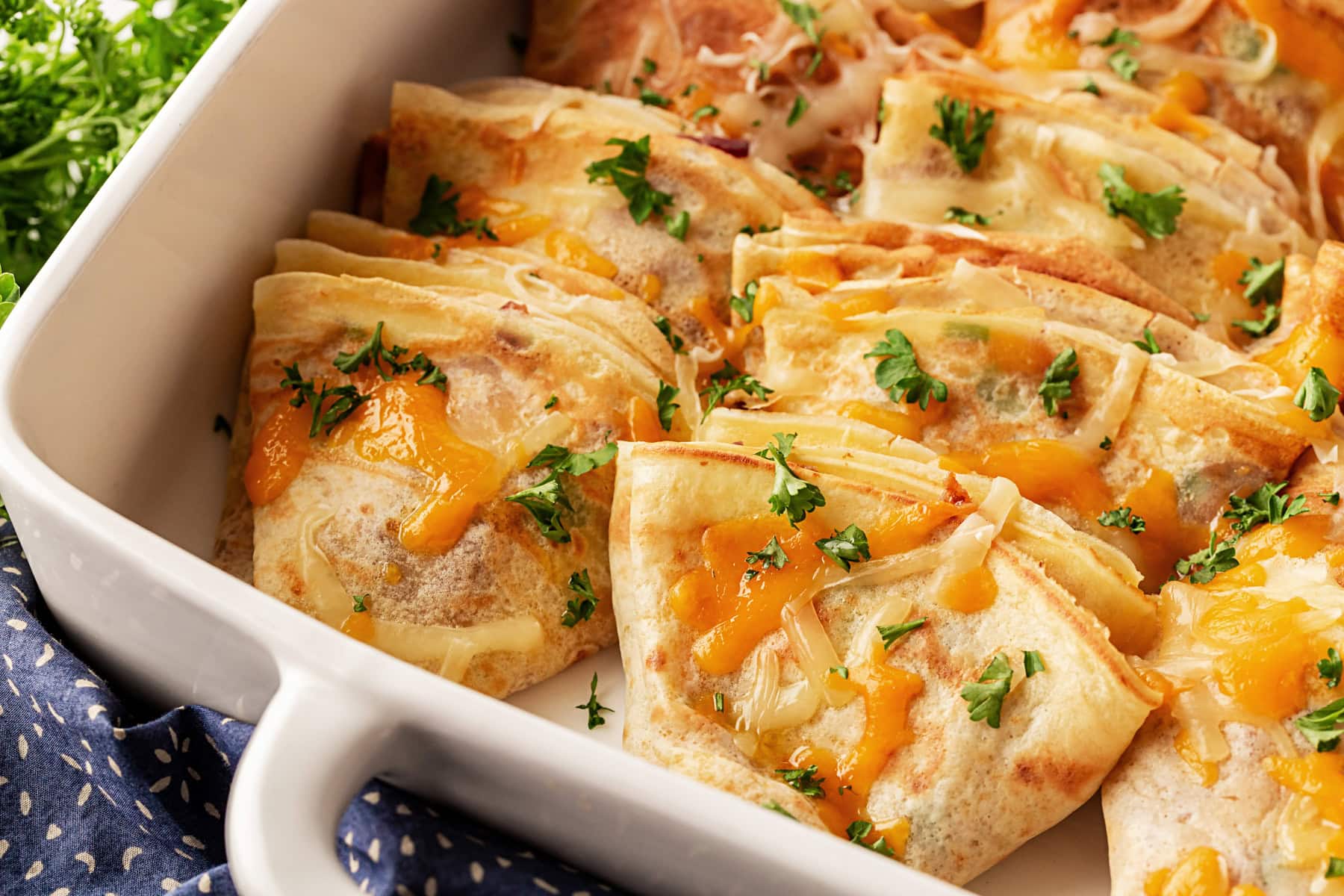 This recipe for Crepes Lorraine is a time-honored treasure that I have been making for over 40 years. Friends and family love this recipe, and I am thrilled to offer it to you also. Crepes in a casserole.