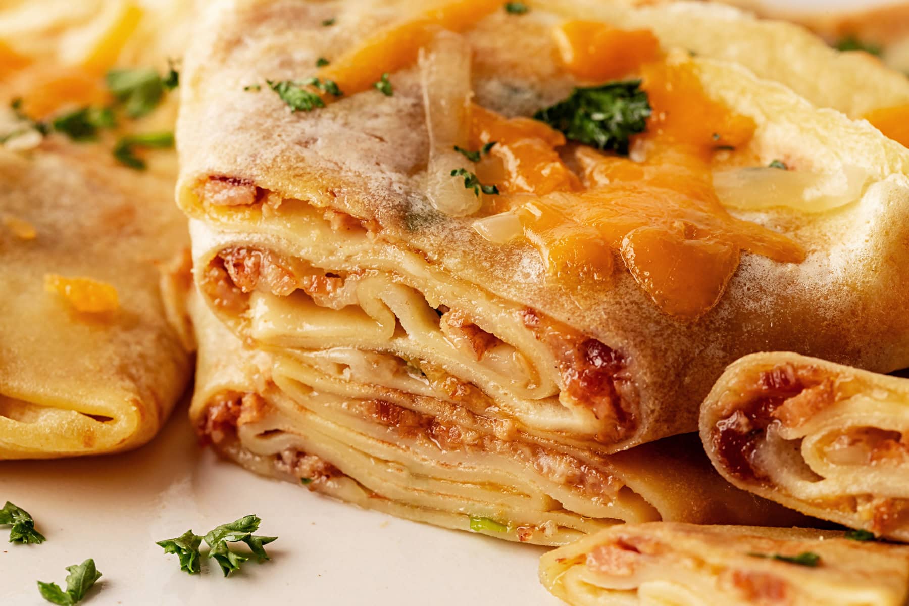 This recipe for Crepes Lorraine is a time-honored treasure that I have been making for over 40 years. Friends and family love this recipe, and I am thrilled to offer it to you also. Seeing the inside of the crepes.