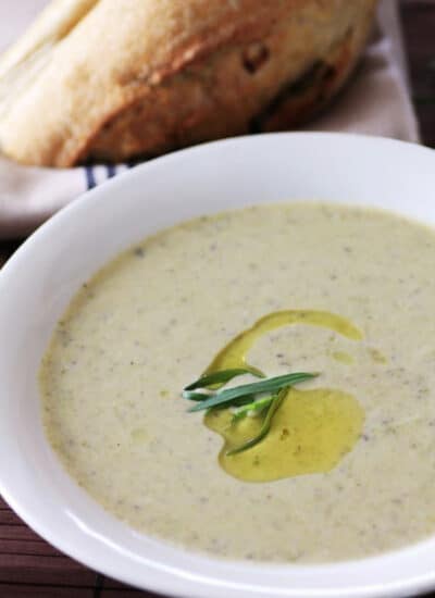Creamy Roasted Asparagus Brie Soup in a white shallow bowl.