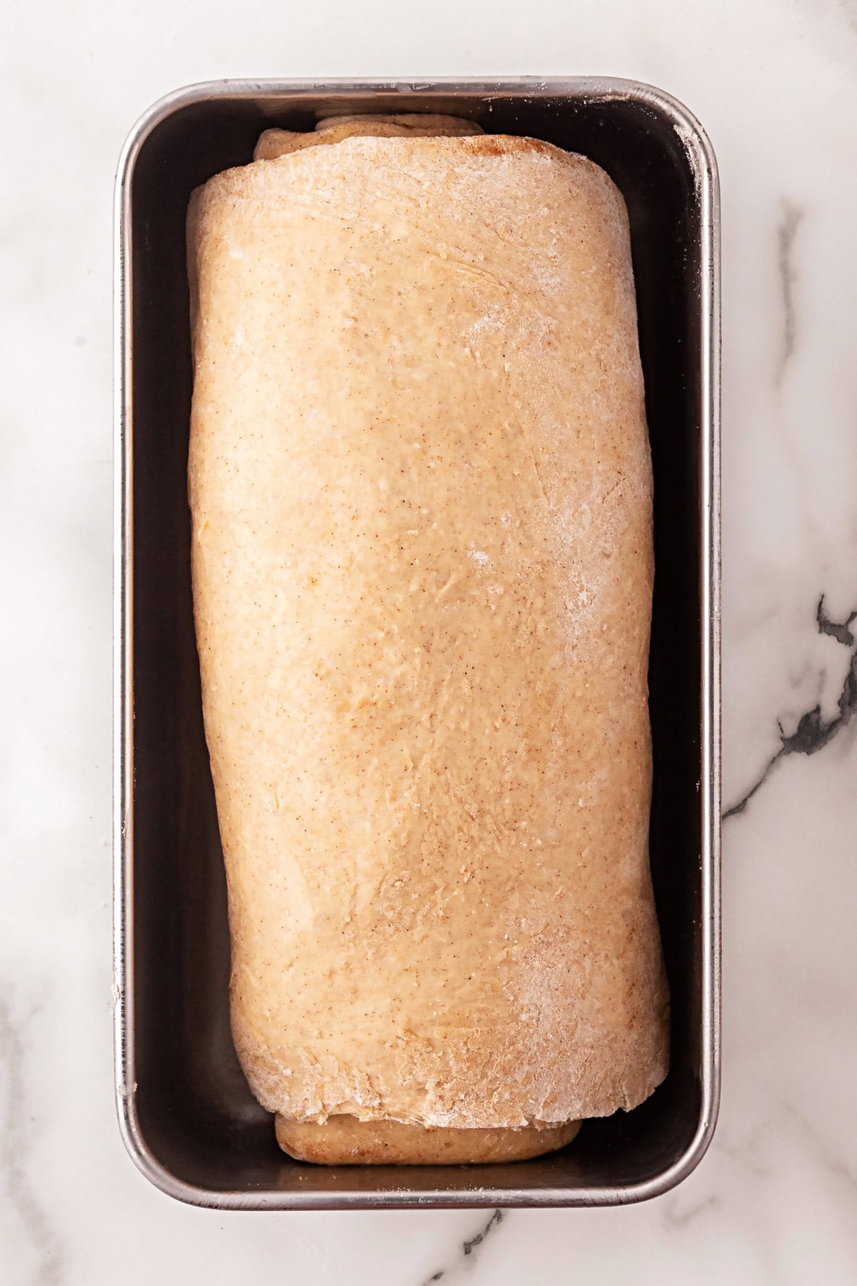 This Cinnamon Swirl Bread is one of the best homemade breads you can make. The bread is light and fluffy, with an amazing cinnamon swirl that you will be addicted to. The finished loaf ready for the oven.
