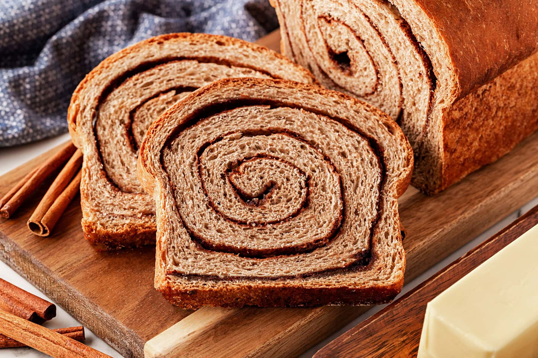 This Cinnamon Swirl Bread is one of the best homemade breads you can make. The bread is light and fluffy, with an amazing cinnamon swirl that you will be addicted to. Slices of bread from the loaf.