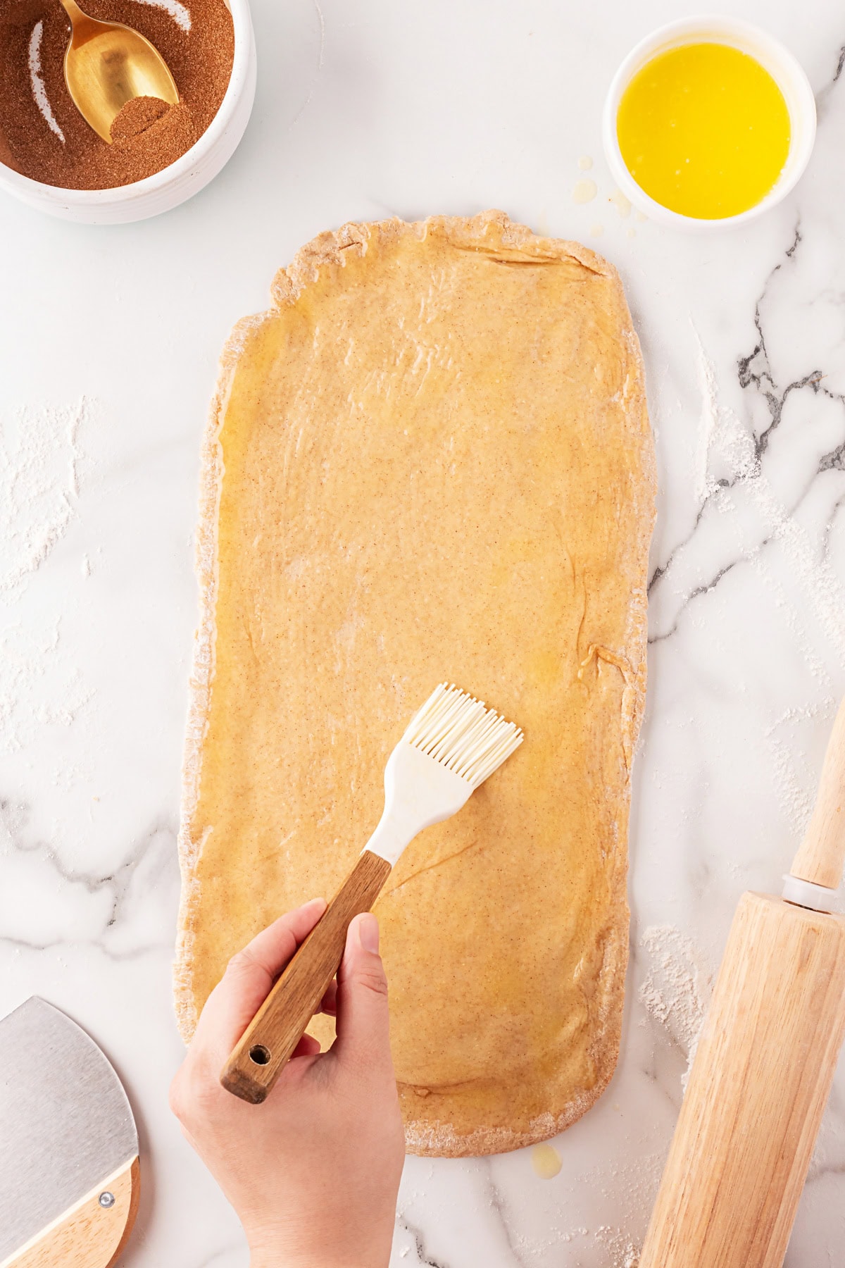 This Cinnamon Swirl Bread is one of the best homemade breads you can make. The bread is light and fluffy, with an amazing cinnamon swirl that you will be addicted to. Painting the dough with butter.
