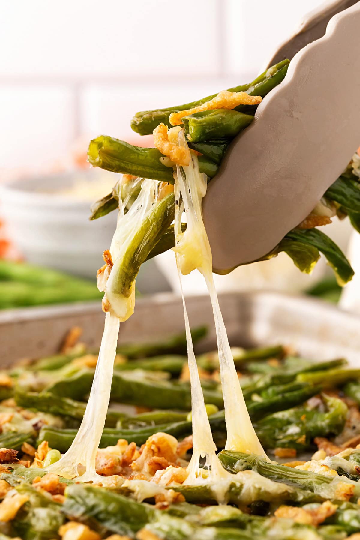 Oven Roasted Green Beans with tongs. 