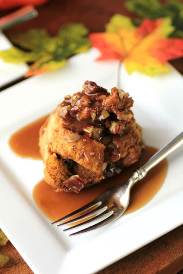 Tipsy Pumpkin Bread Pudding  on a white plate with a fork