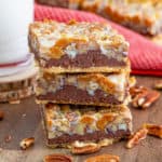 Stacked Turtle Bars on a wooden board with pecans around