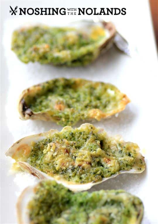 Oysters Rockefeller on a white plate with salt