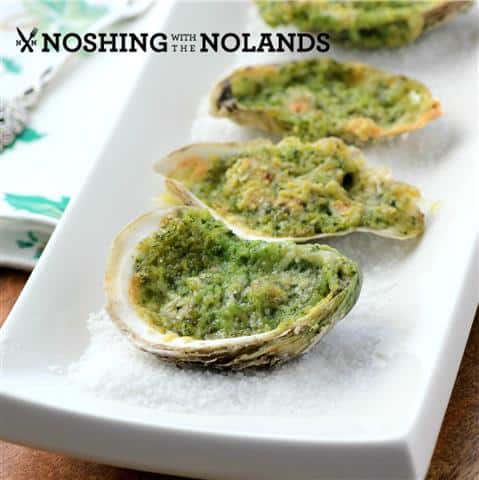Oysters Rockefeller on a white plate with salt