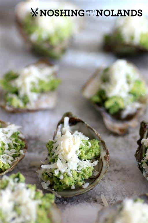 Oysters Rockefeller before they go in the oven on a baking sheet