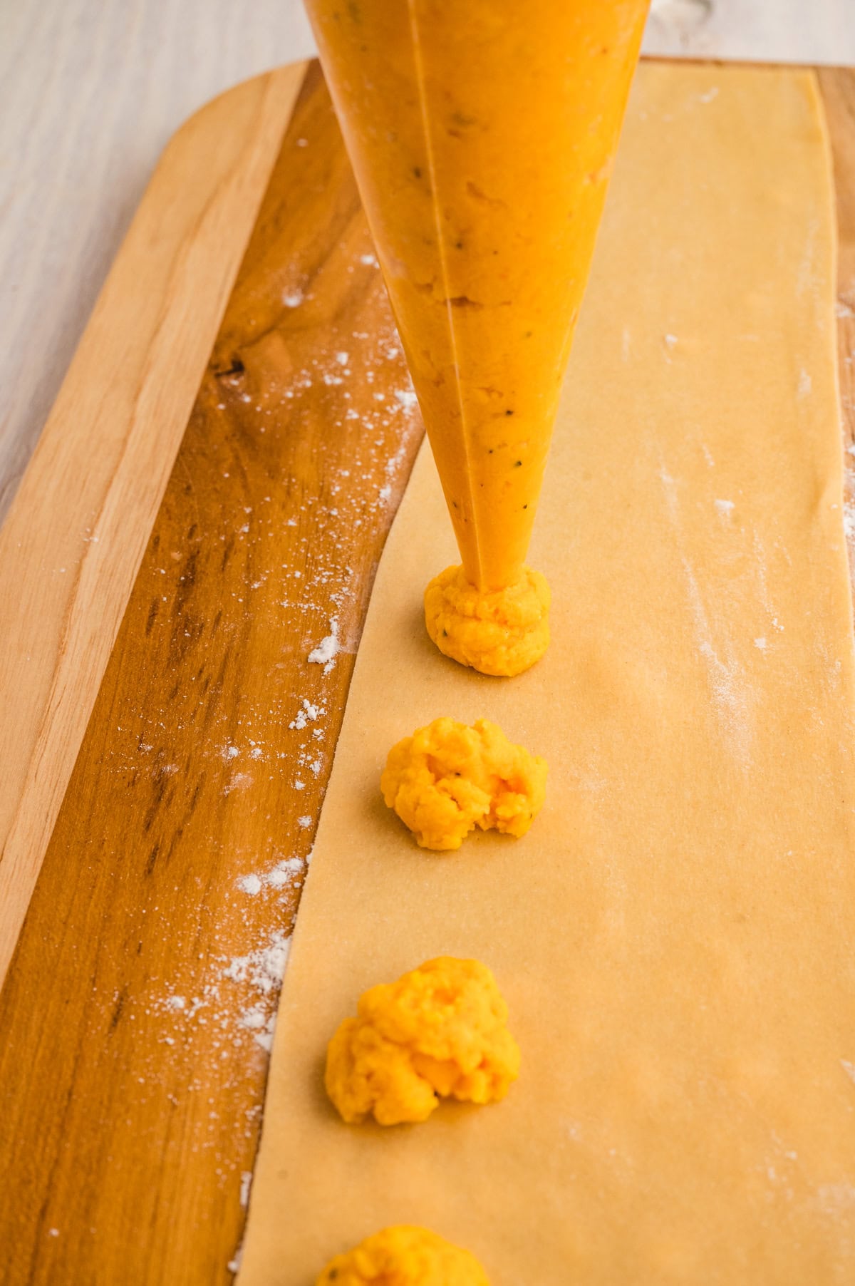 Adding filling to pasta. 