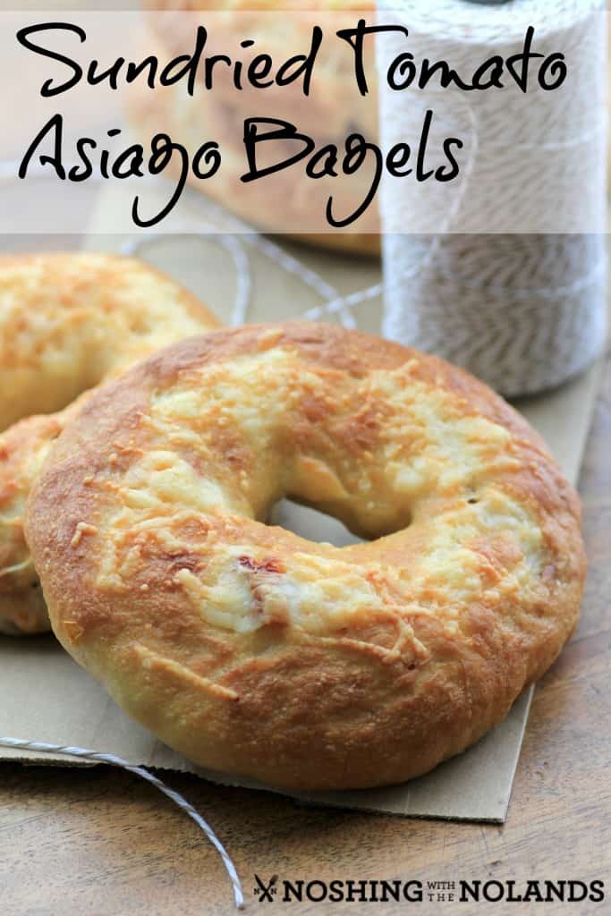 Sundried Tomato Asiago Bagels on a napkin, sitting on a wooden board