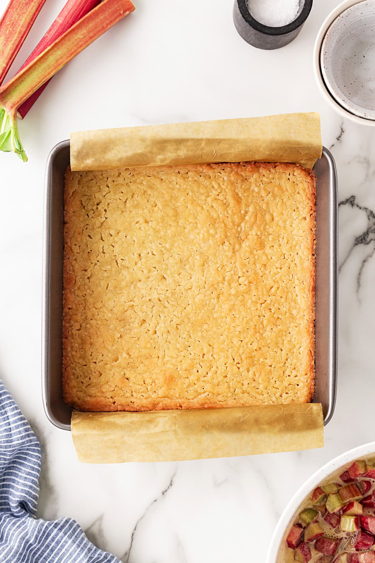 Rhubarb Dream Bars are the perfect rhubarb lover's treat! They are rich and gooey, tart and sweet and make for an exquisite dessert with little effort. Baked crust.