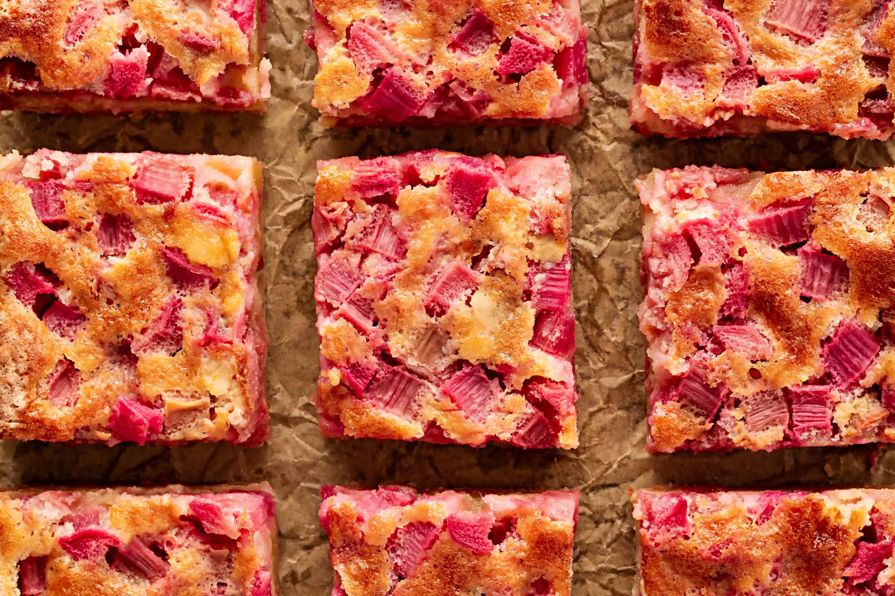 Rhubarb Dream Bars are the perfect rhubarb lover's treat! They are rich and gooey, tart and sweet and make for an exquisite dessert with little effort. Horizontal of overhead bars.