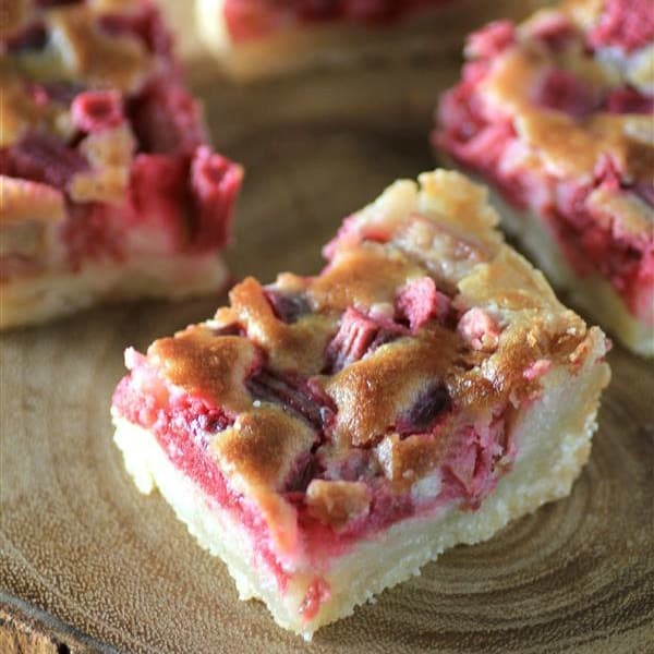 Rhubarb Dream Bars on a wooden serving platter