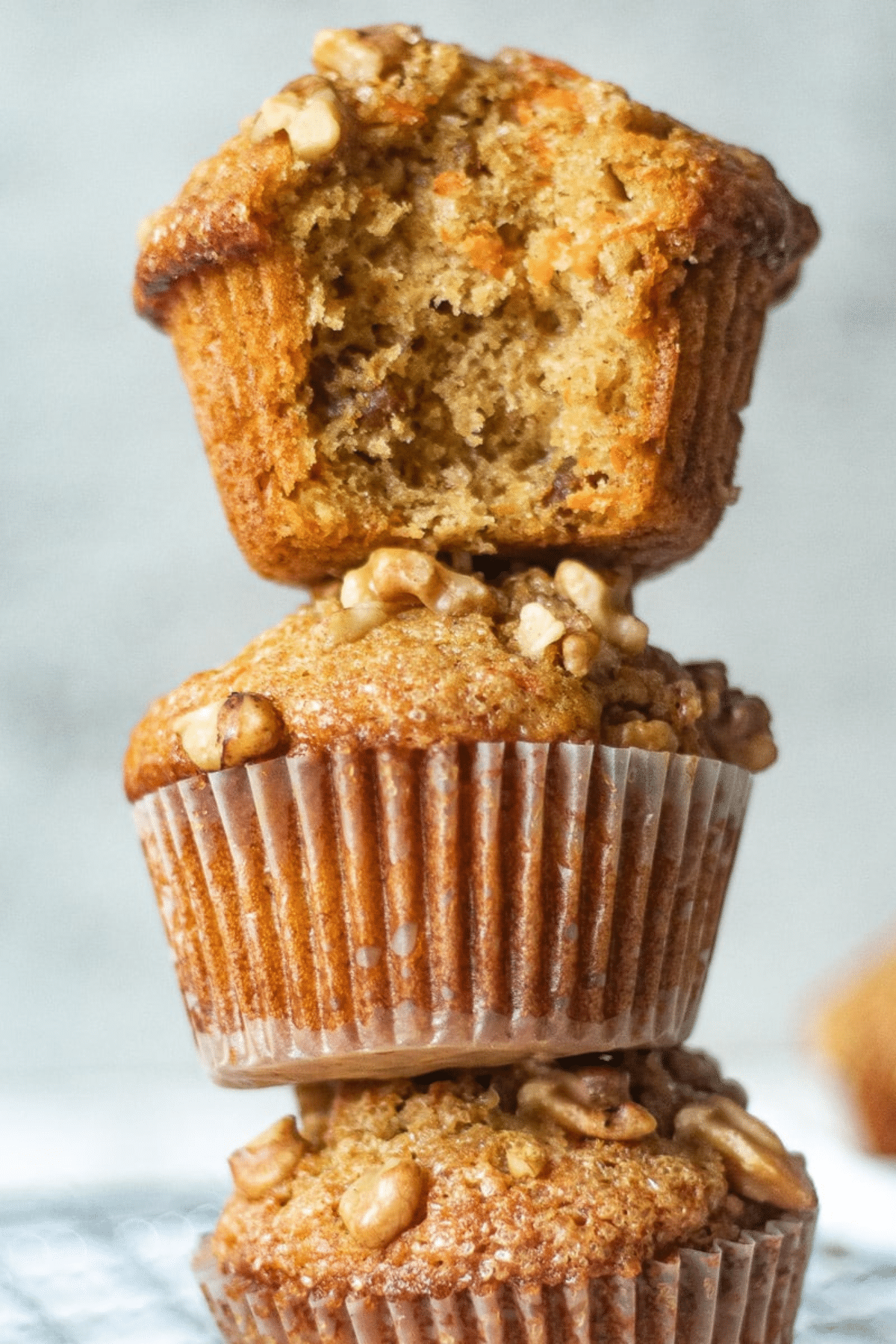 Banana Carrot Muffins stacked on each other.