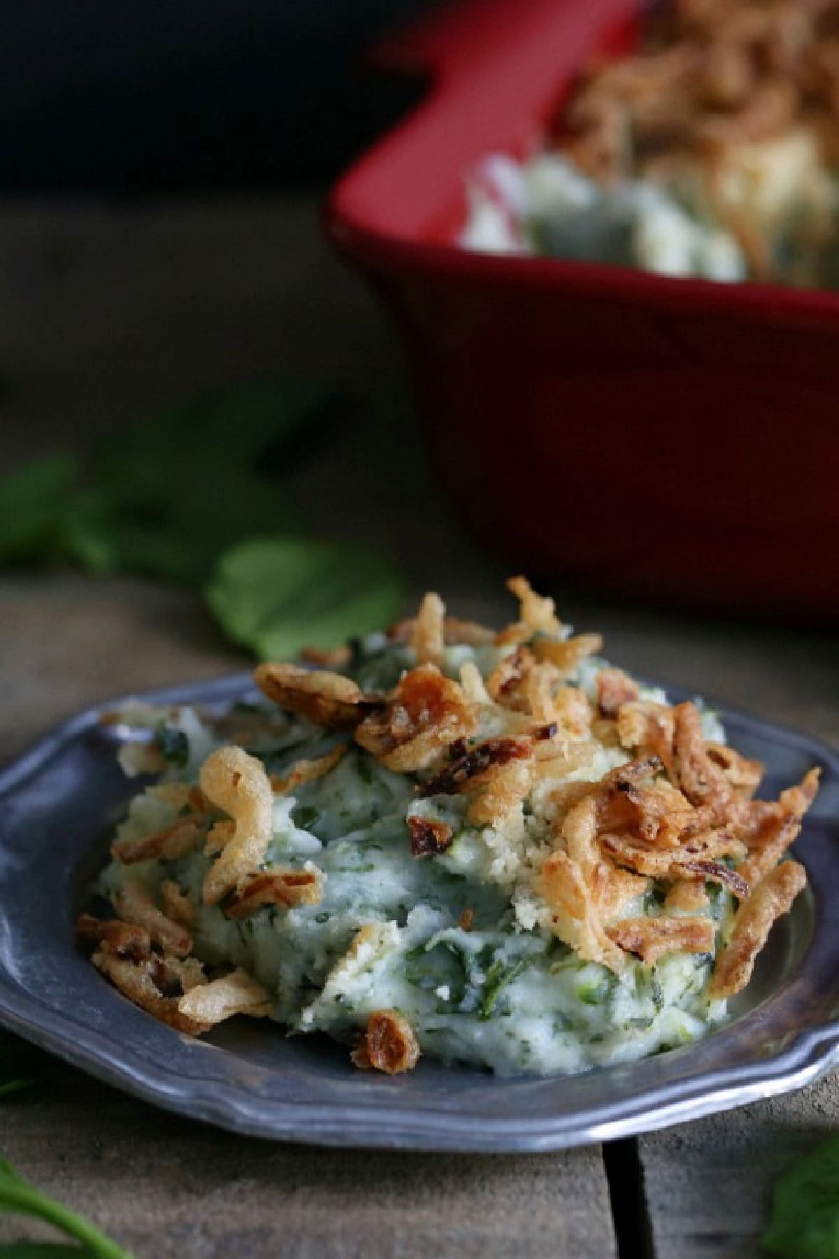 Spinach Parmesan Baked Mashed Potatoes served on a silver plate. 