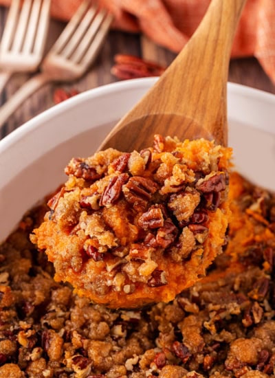 Taking a spoonful of sweet potatoes.