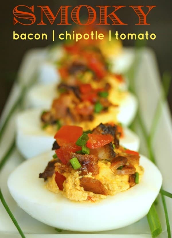 https://noshingwiththenolands.com/wp-content/uploads/2016/01/Smoky-Tomato-Bacon-Chipotle-Deviled-Eggs-chives-green-white-hard-boiled-egg-serving-platter-text1-1-Custom.jpg