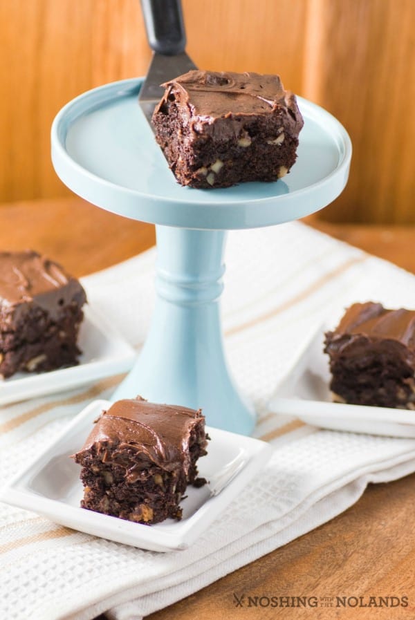 Brownie on a pedestal with other brownies around it. 