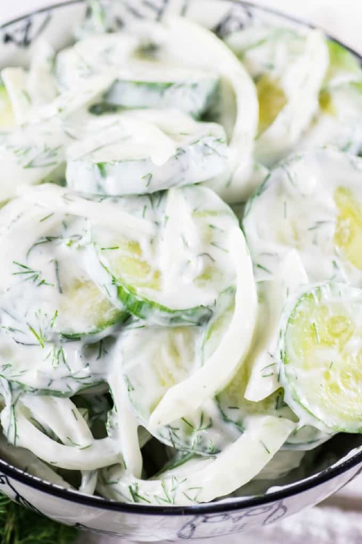 Get outside and enjoy the day with these 50 Picnic Basket Essentials. There is something for everyone to pack the perfect picnic and enjoy family time and the great outdoors. Creamy Cucumber Salad in a bowl.