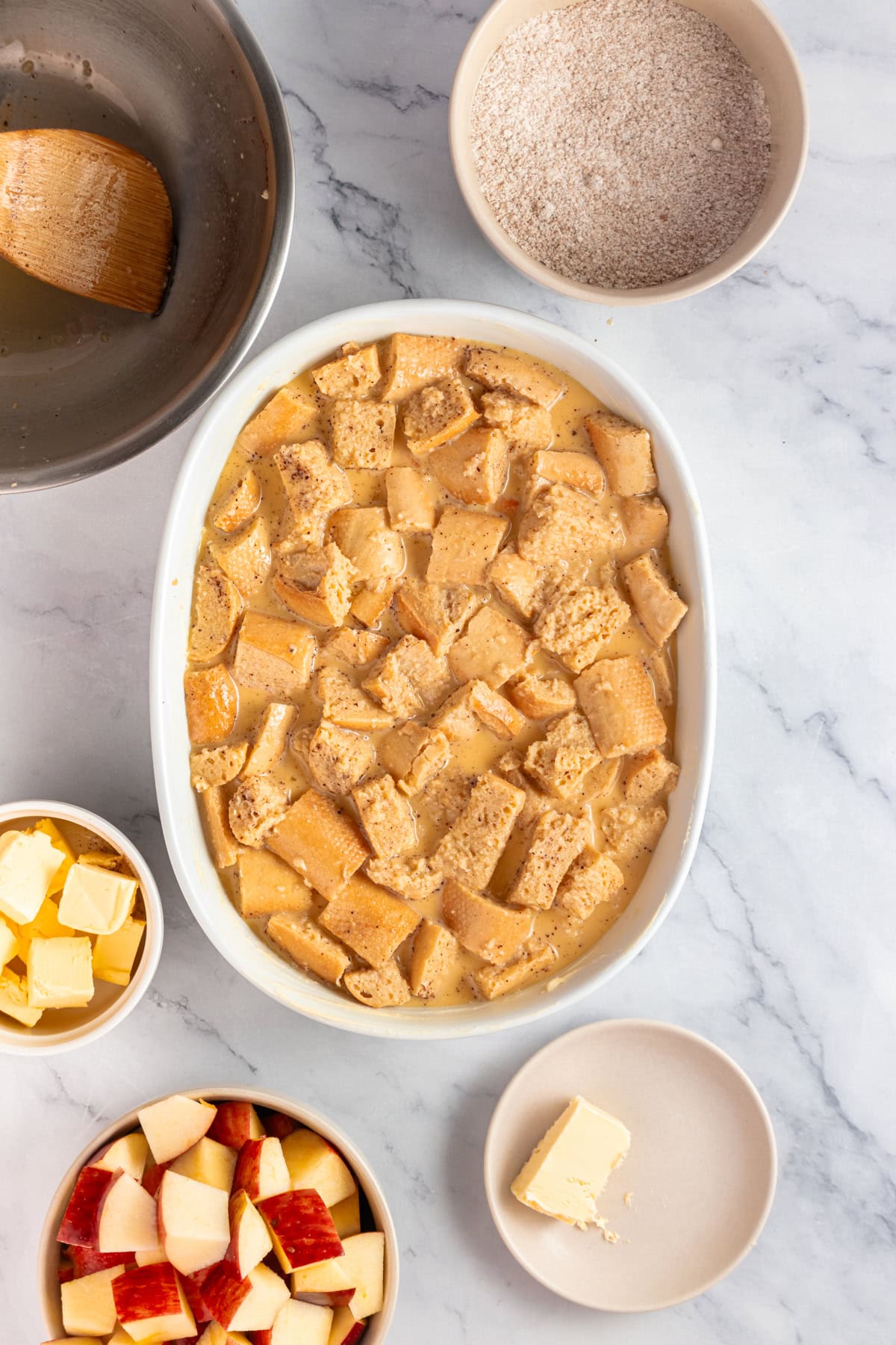 Spoon the soaked bread into the prepared baking dish.