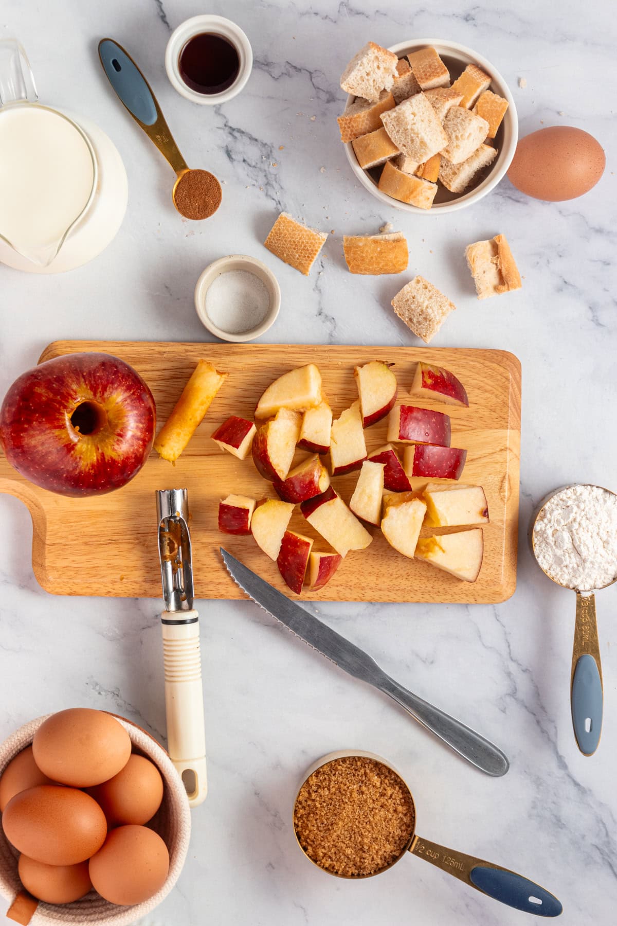 Coring and chopping apples on a wooden board.