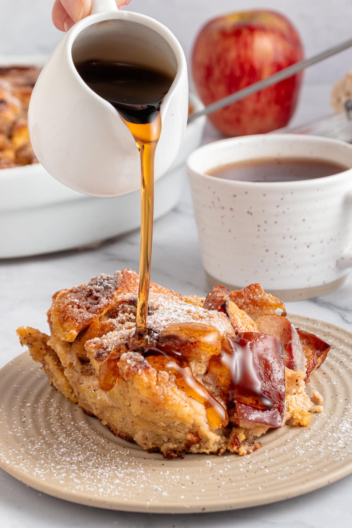 Maple syrup being poured over the french toast casserole.