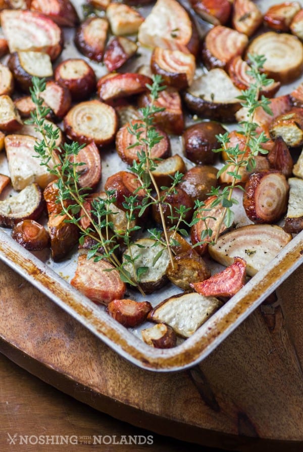 Roasted Chioggia Beets on a baking sheet with a srig of thyme