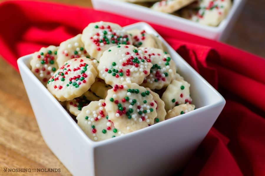 Festive Shortbread Bites in a white bowl with a red napkin at the side