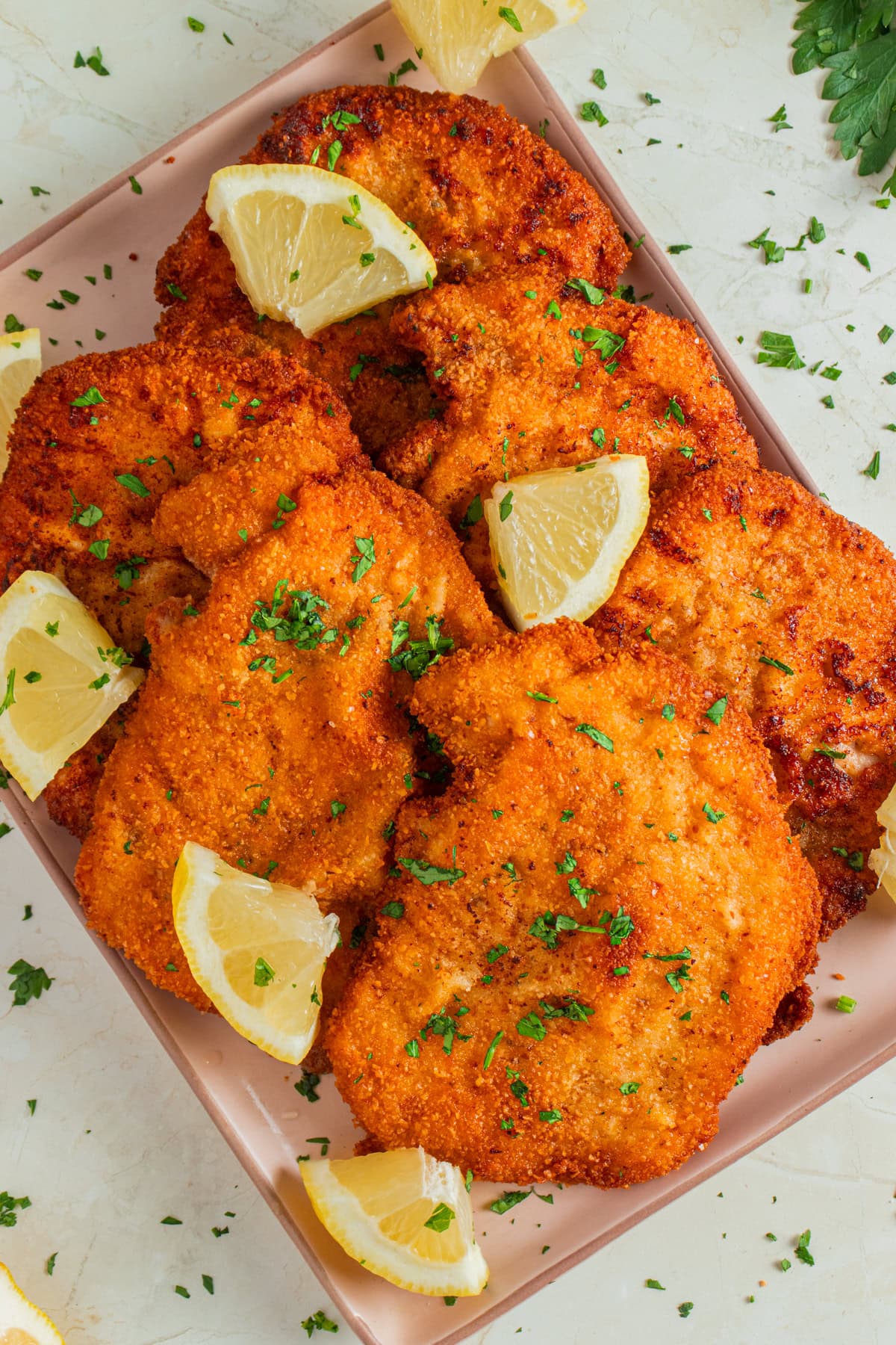 Pork Schnitzel with lemon wedges.