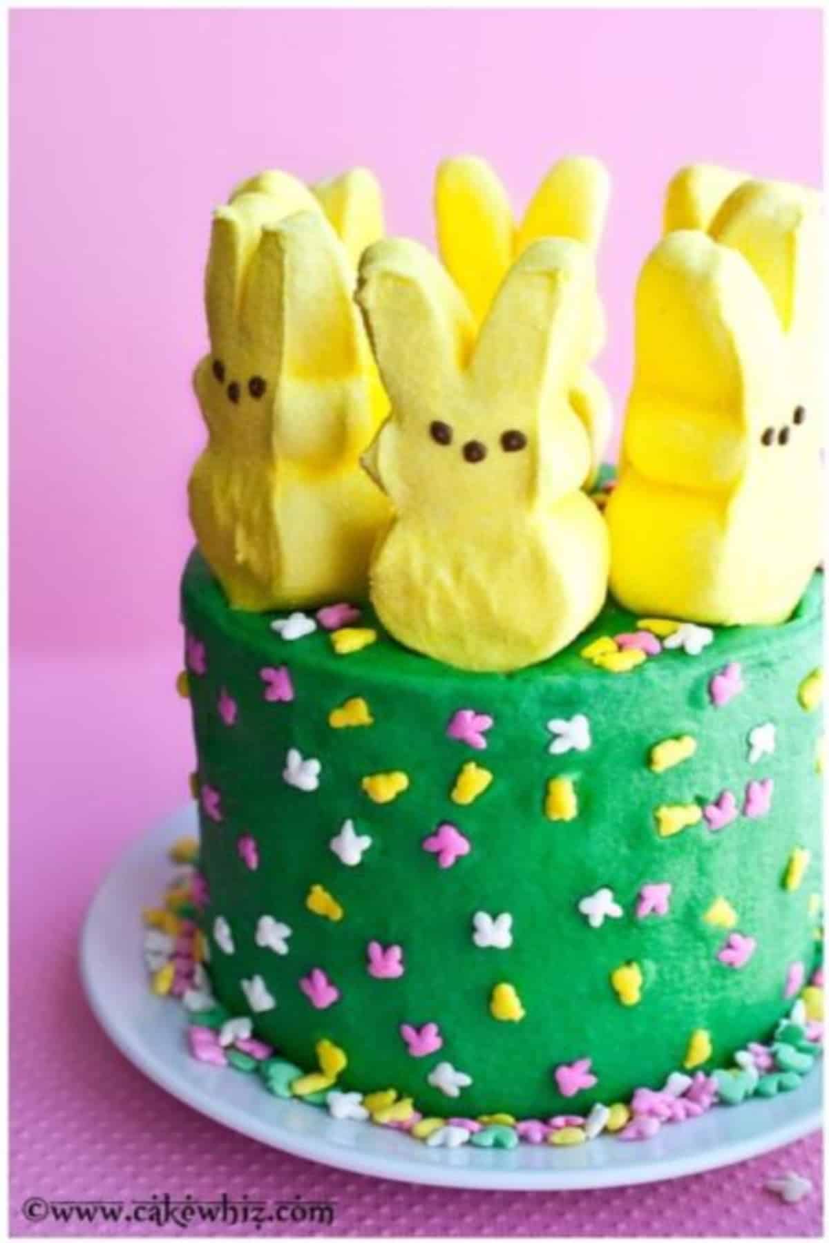 Easter Peeps Cake on a plate with pink background.