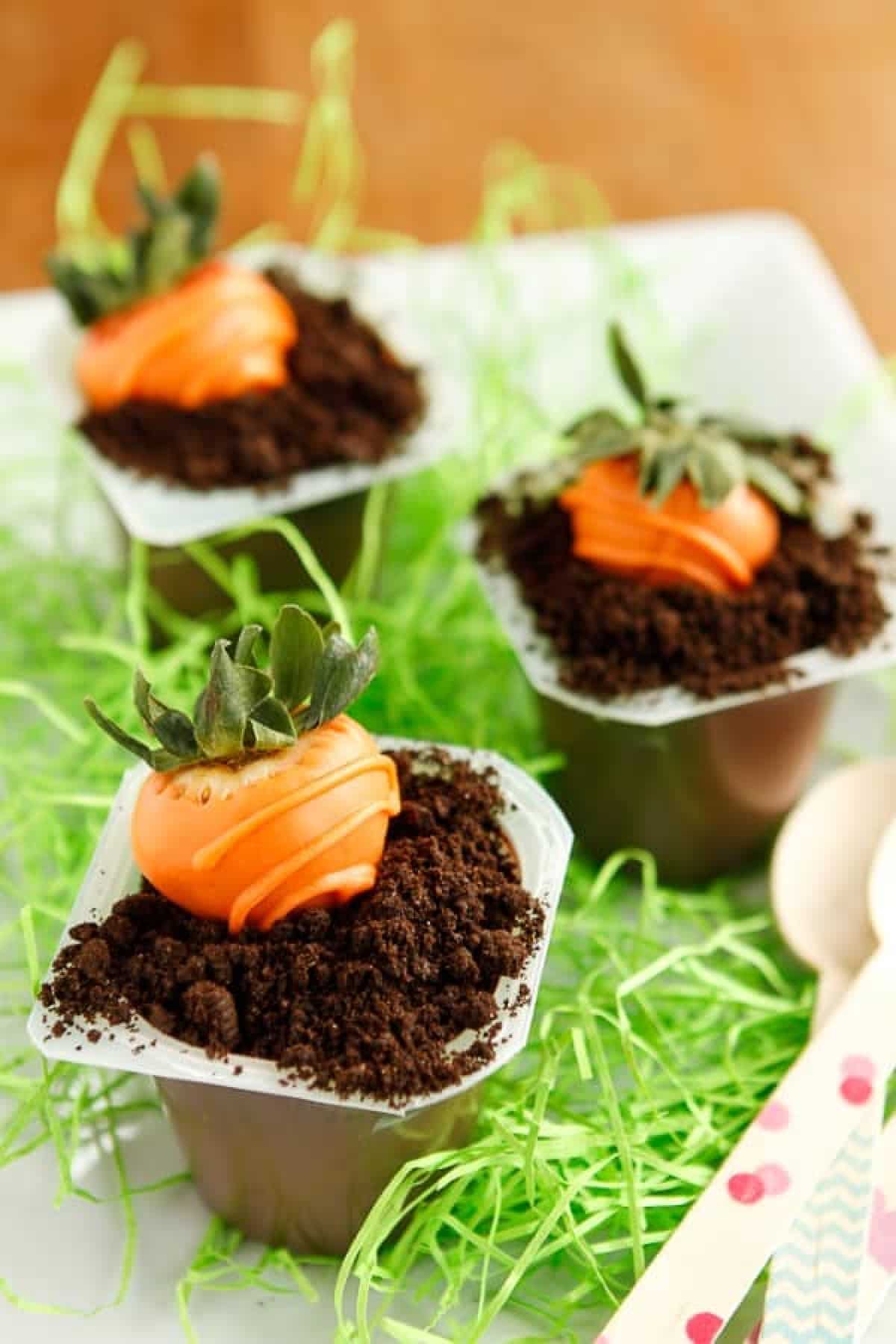 Three Carrot Patch Oreo Dirt Cups on a plate.