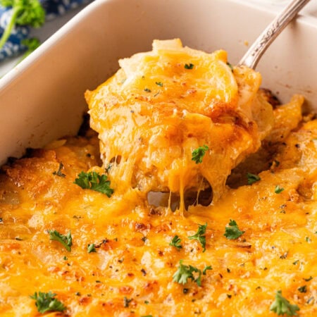 Taking a spoonful of Cheesy Scalloped Potatoes.