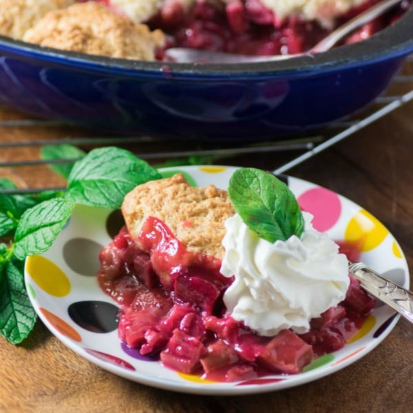 Rhubarb Strawberry Cobbler on a plate with mint