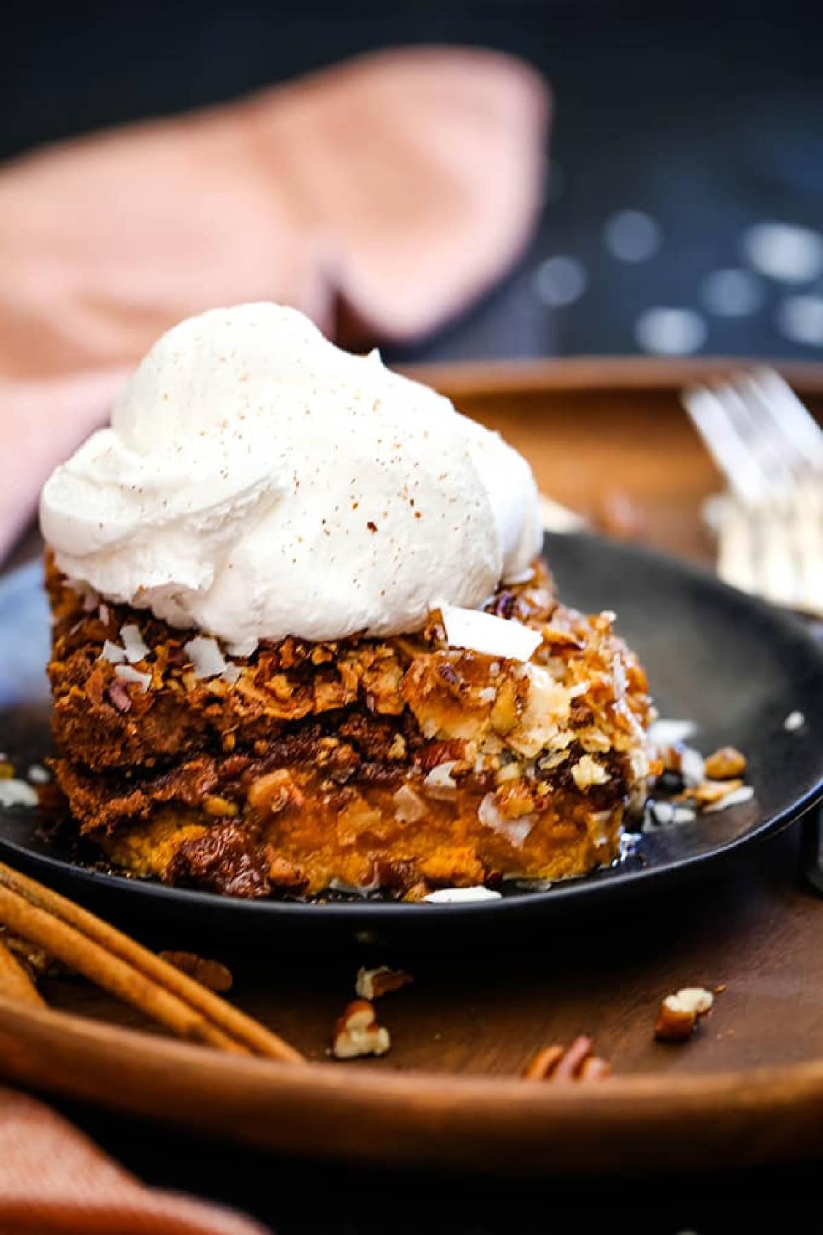 Slice of German Chocolate Upside Down Pumpkin Pie on a plate. 