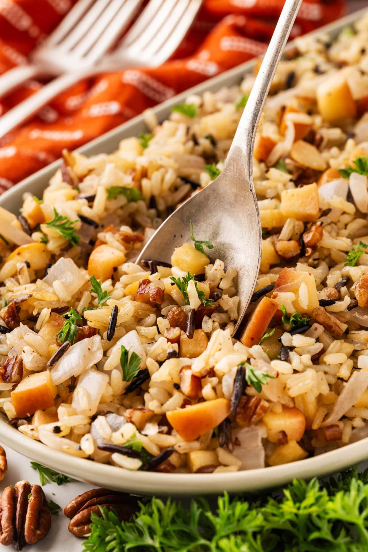 Putting a spoon into the wild rice dish. 