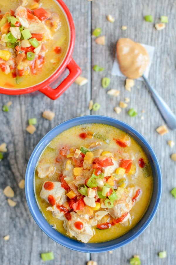 Thai Peanut Chicken Soup in a blue bowl and a red bowl