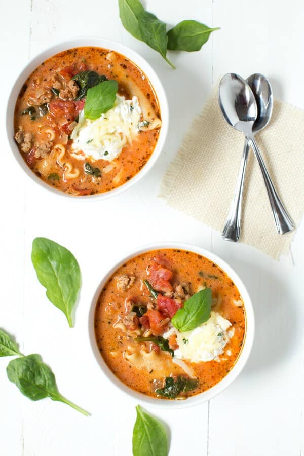 Spinach Lasagna Soup in white bowls with spoons on the side