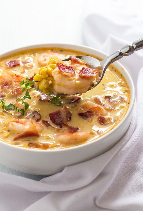 Bacon Shrimp and Corn Chowder in a bowl being spooned out. 