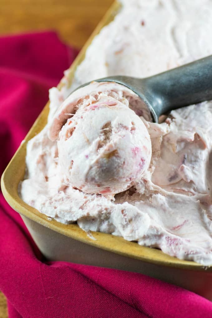 No Churn Rhubarb Ice Cream being scooped out of a container