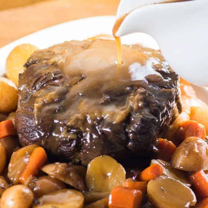 Pressure Cooker Roast Beef with gravy being poured on top