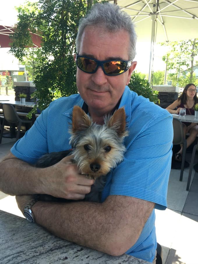 Ken holding Ziggy outdoors on a patio