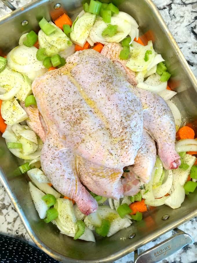 Chicken and vegetables in a roasting pan ready to go into the oven
