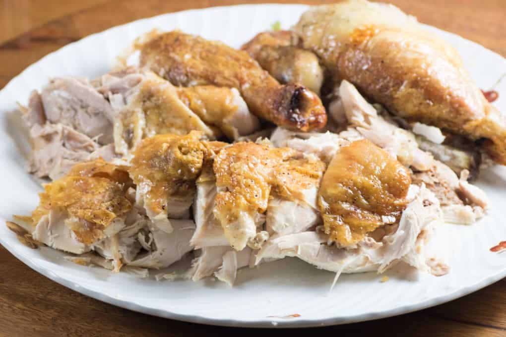 Roast chicken carved up on a platter