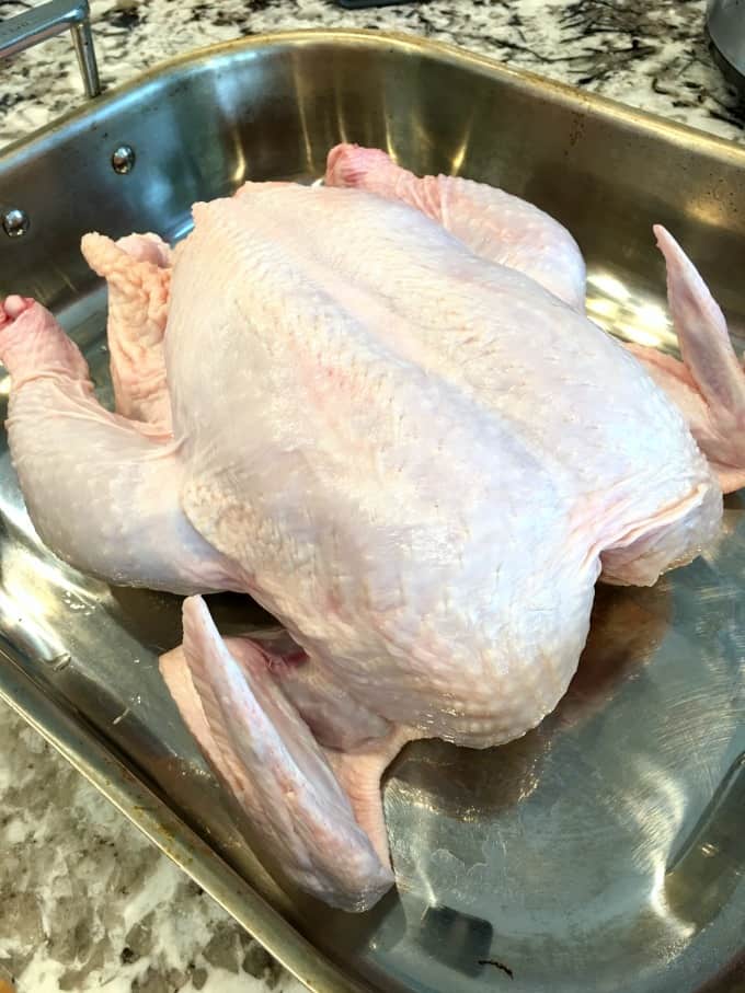 Uncooked chicken in a roasting pan
