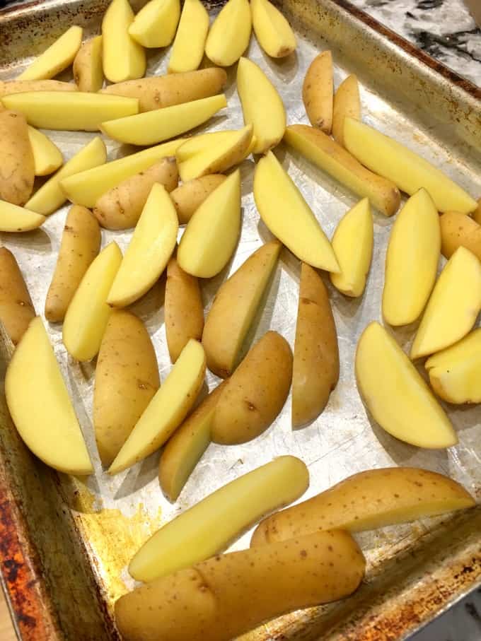 Fingerling potatoes sliced on a baking sheet
